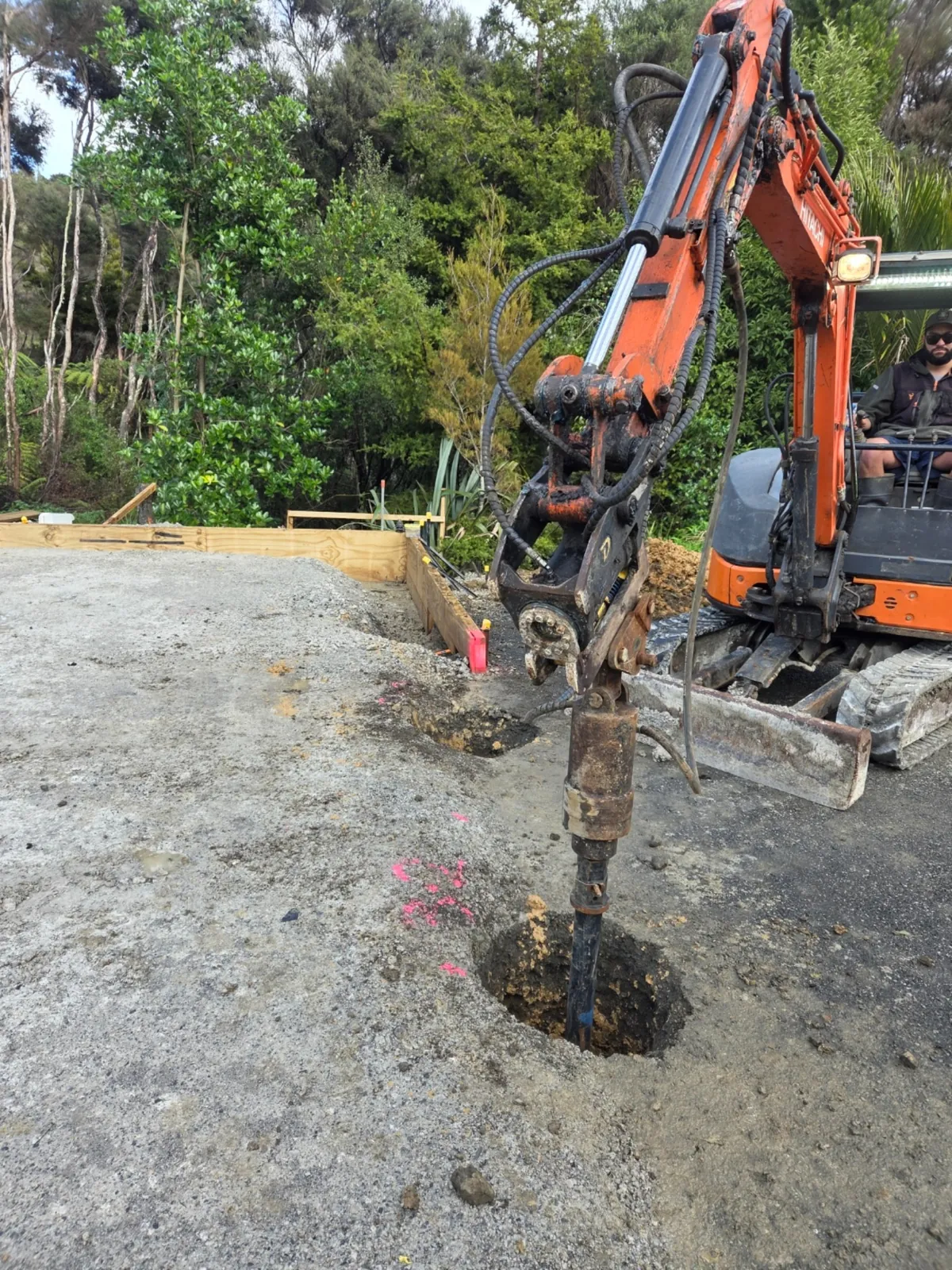 Excavator drilling hole on Auckland site